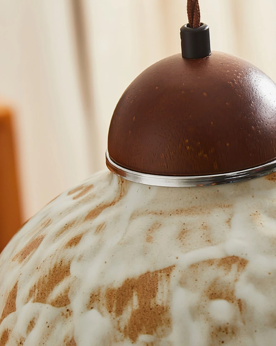 Top-down view of Wella pendant canopy showing dark walnut wood and hand-twisted fabric cord