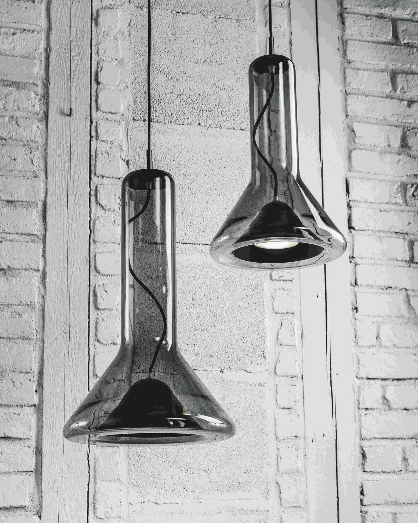 Whistle pendant lamp suspended from ceiling wire showing full silhouette and proportions