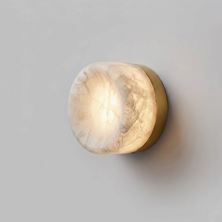 Concave disc alabaster wall sconce with white alabaster shade and brass metal base, studio product photography