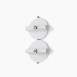 Dual modern minimalist white wall sconces with chrome hardware mounted on white wall, studio shot