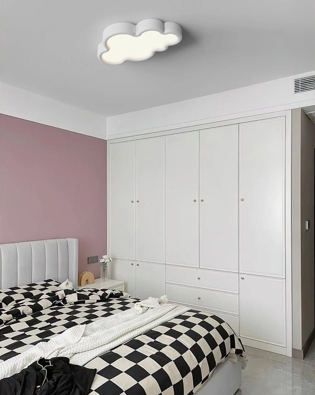 White cloud ceiling lamp in contemporary bedroom with checkered bedding minimal design