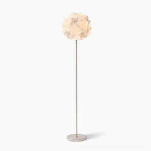 Modern flower floor lamp with white diffuser and silver metal stand on minimalist white background