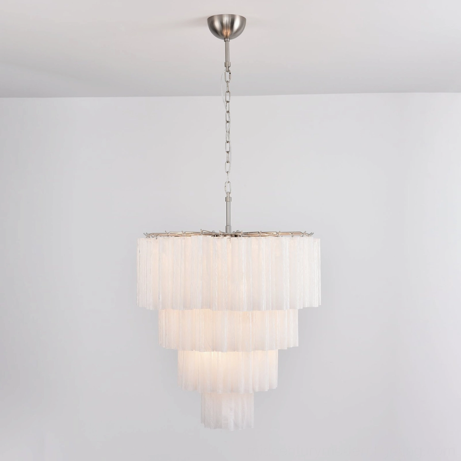 White serene tiered glass chandelier minimalist gallery aesthetic clean sculptural form