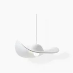 White modern straw hat pendant light with curved brim design, studio close-up shot