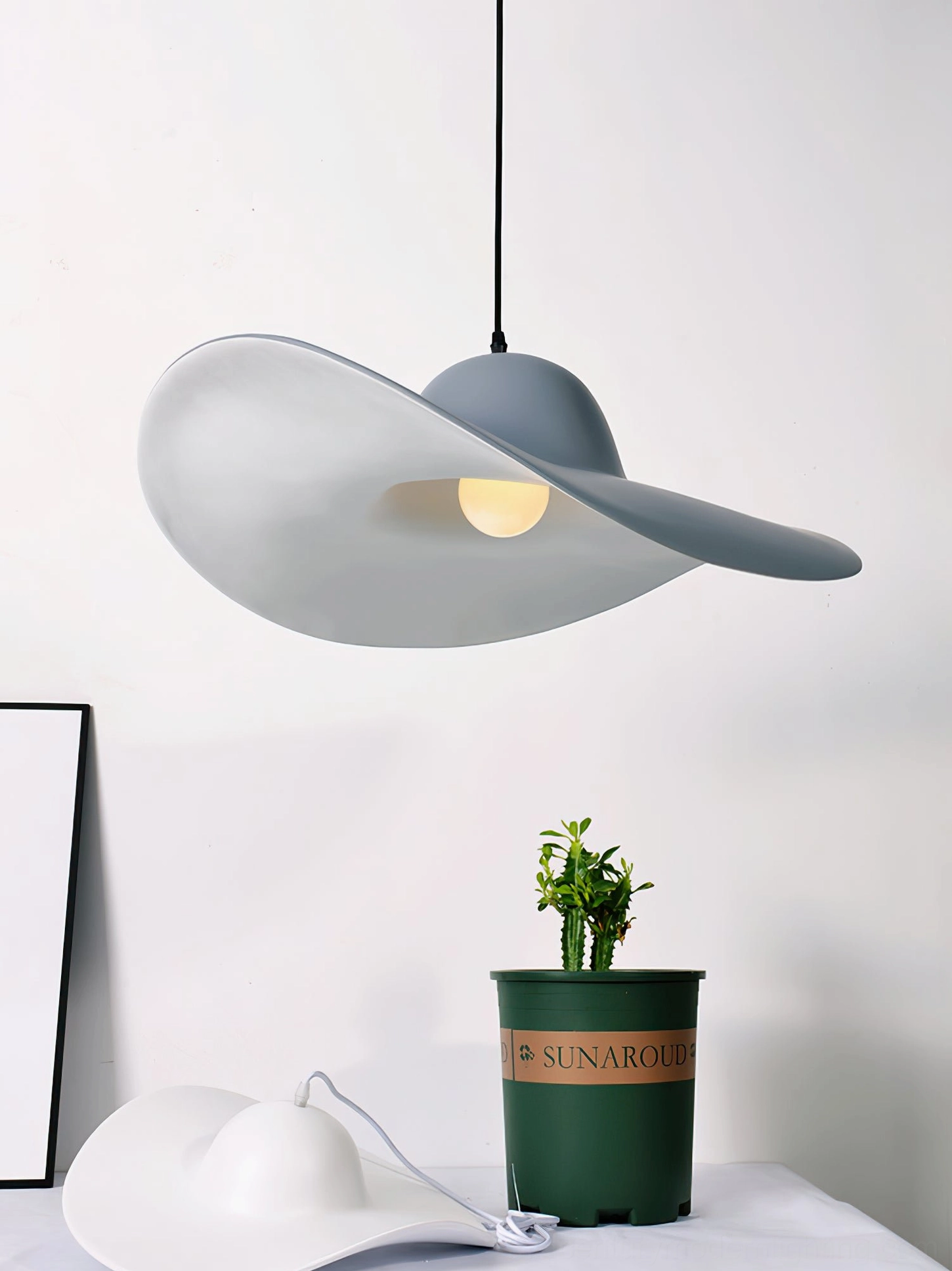 Pair of white hat-shaped pendant lights for dining room cluster installation