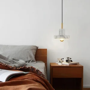 White marble pendant lamp displayed on modern minimalist nightstand in Scandinavian bedroom