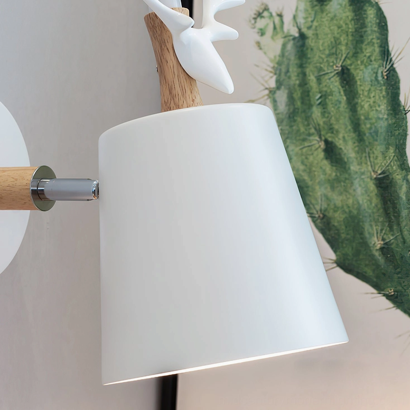 White matte antler wall lamp with metal and wood hardware, side close-up showing contemporary design details
