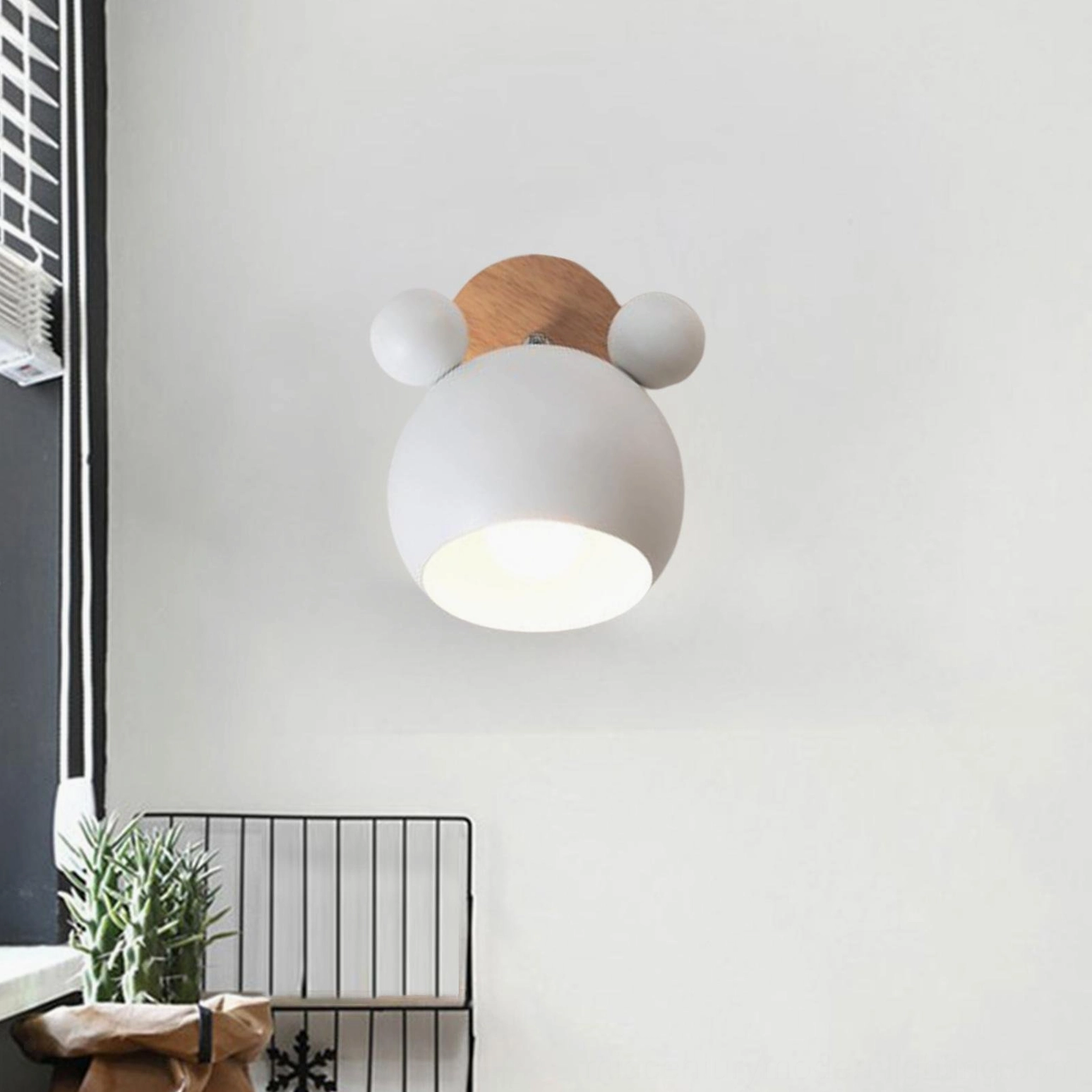 Minimalist white mouse sconce mounted on entry hallway wall with Scandinavian decor