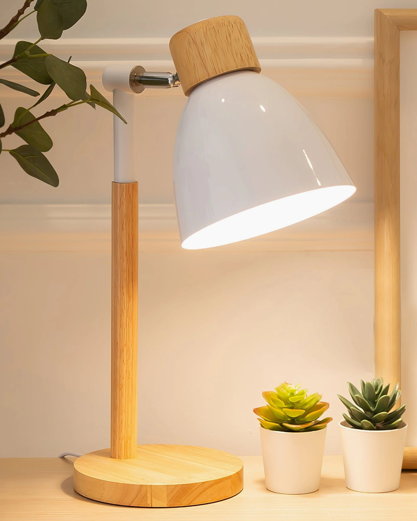 White shade wood table lamp three-quarter side view with succulent potted plants, cozy Nordic minimalist interior