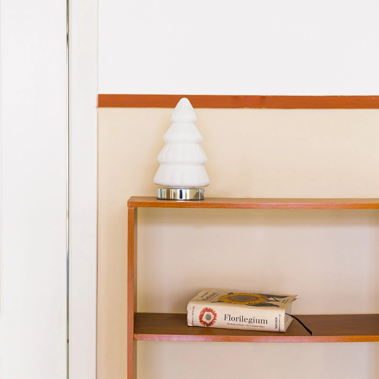 Unlit white ceramic tree lamp showing ribbed structure and geometric form on wooden wall-mounted shelf