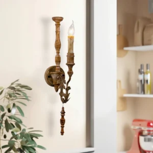 Farmhouse wall sconce in natural interior setting with greenery, showing side angle detail