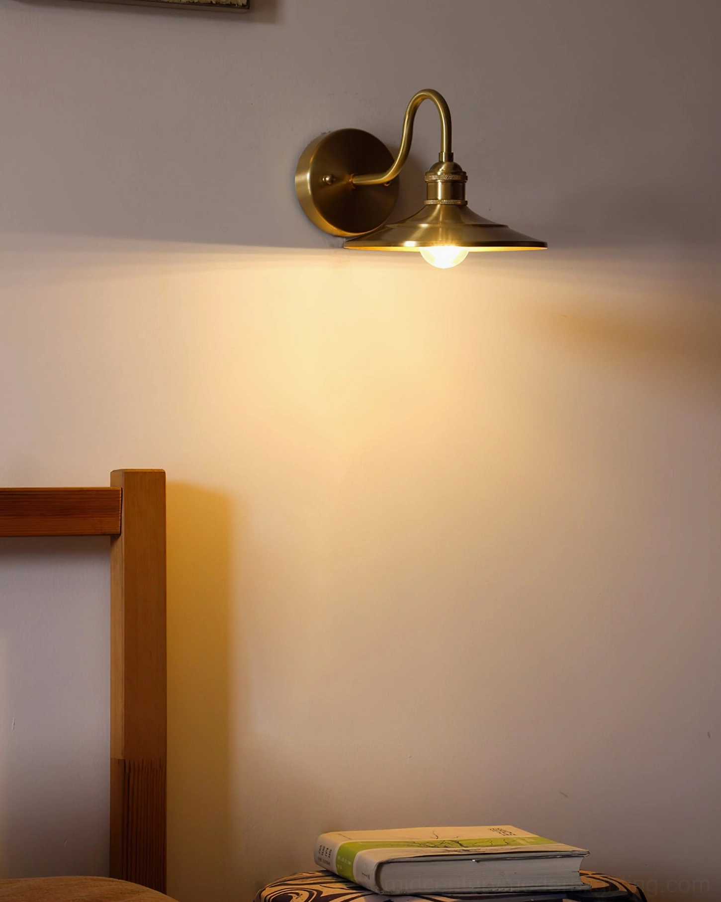 Paired Whizzer mid-century brass wall sconces in minimalist bedroom with neutral wall art and contemporary home decor styling