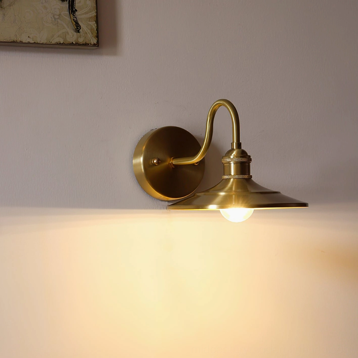 Whizzer mid-century wall lamp illuminated on residential interior wall, overhead angle showing warm ambient lighting