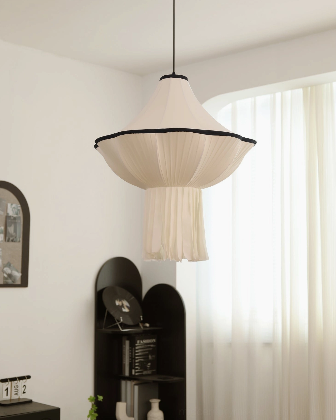 Wildon fabric pendant light showing elegant tapered silhouette and draped pleats near arched window