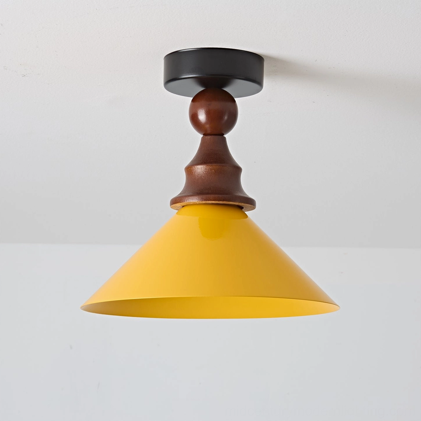 Wilken retro ceiling lamp three-quarter view showing conical yellow shade and wooden stem details