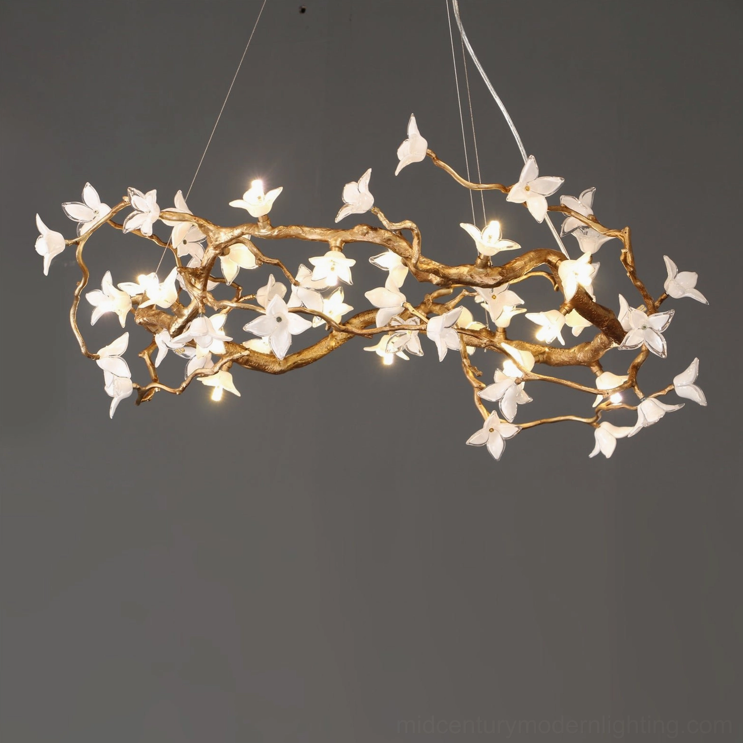 Willow Flower Chandelier frontal view highlighting spaced hand-blown glass flowers on twisted gold brass branches