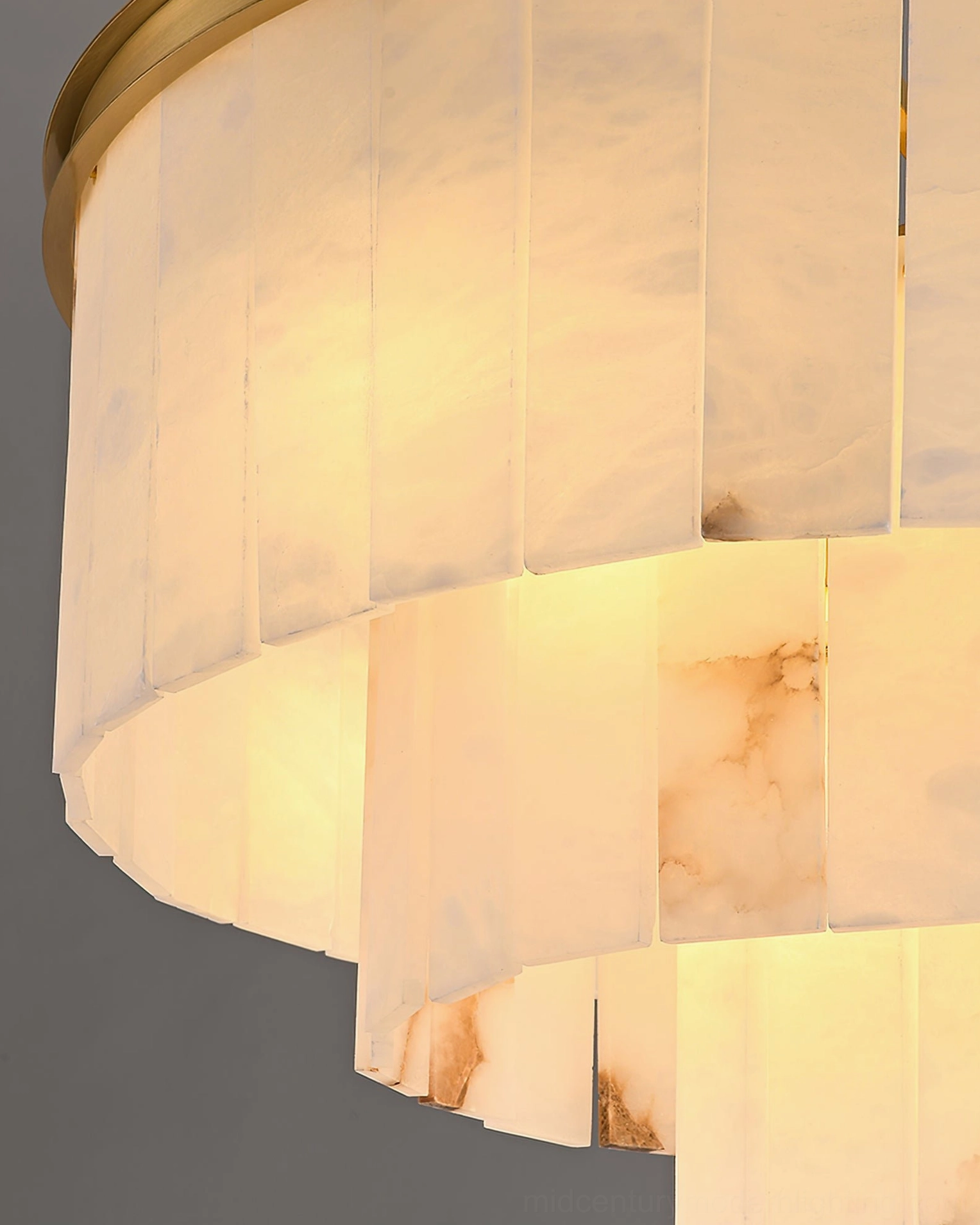 Low-angle view of illuminated alabaster shade panels with warm backlit glow highlighting natural stone texture