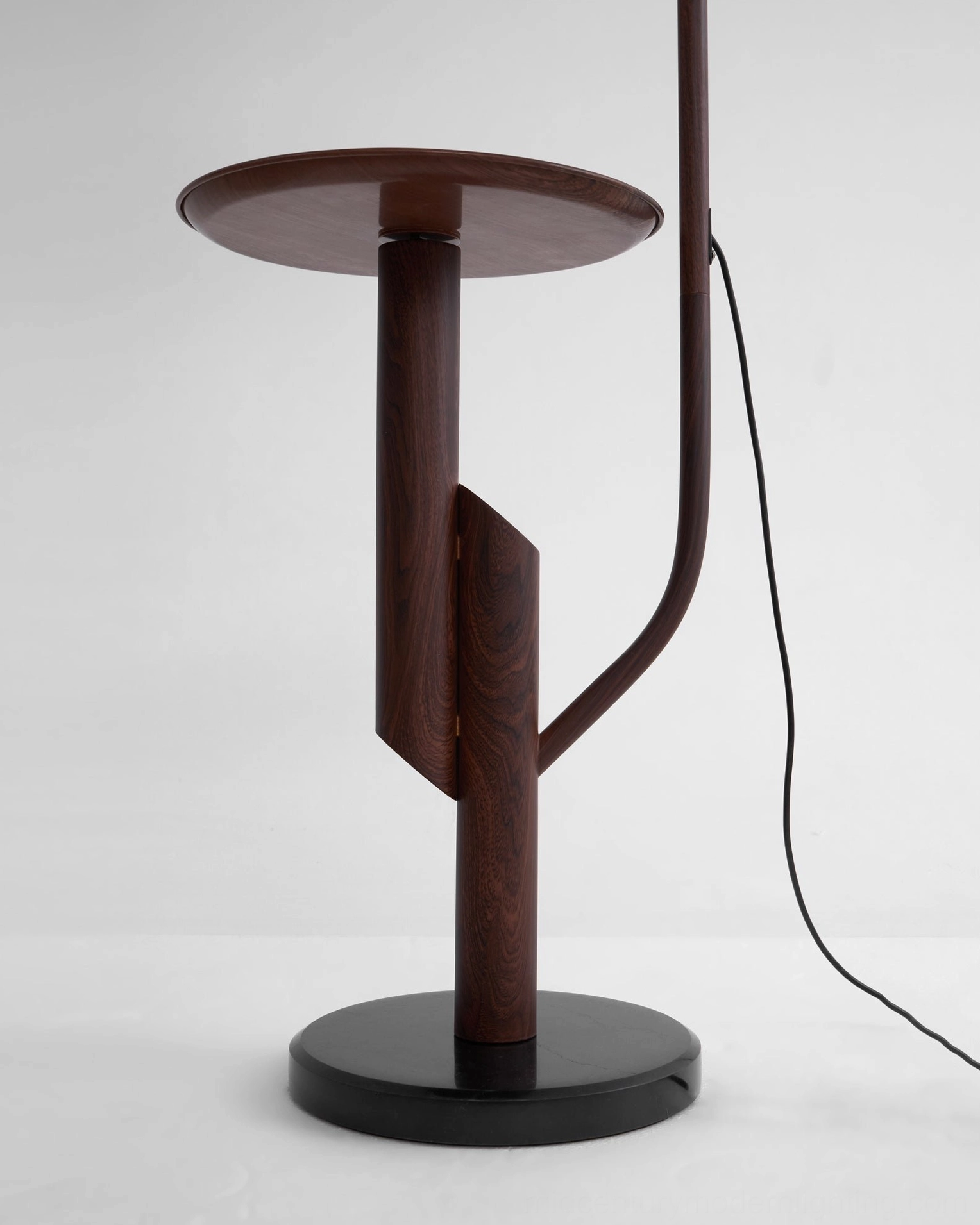 Winona arc floor lamp positioned at bedside, warm light for reading, integrated table for nightstand items
