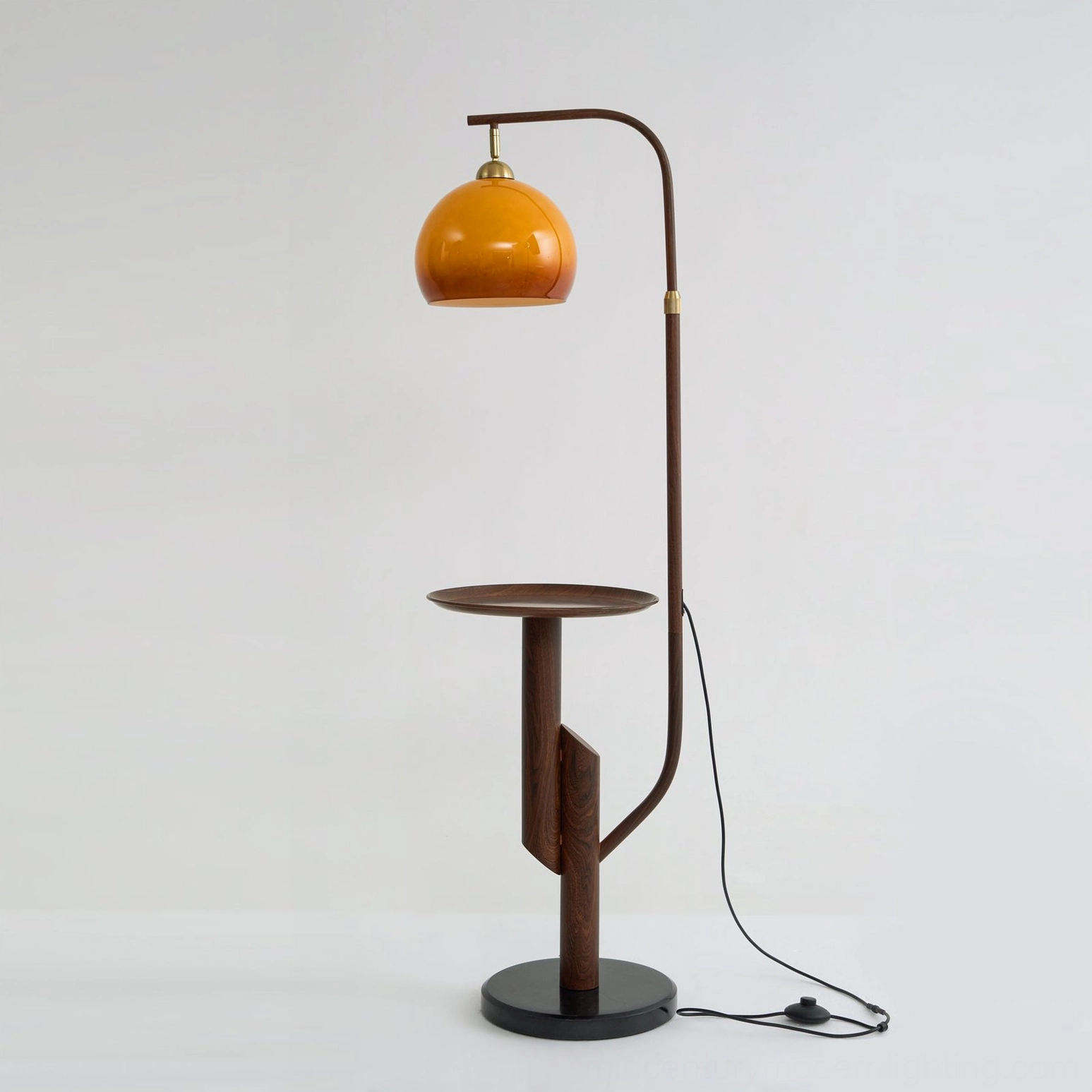 Winona arc floor lamp black finish variant with sleek matte black metal and glowing amber dome