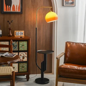 Winona arc floor lamp styled in mid-century modern living room next to leather armchair and wood accents