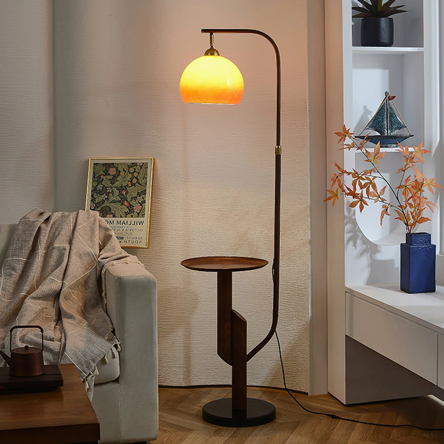 Winona arc floor lamp positioned in modern minimalist home nook with dark wood table and built-in shelving