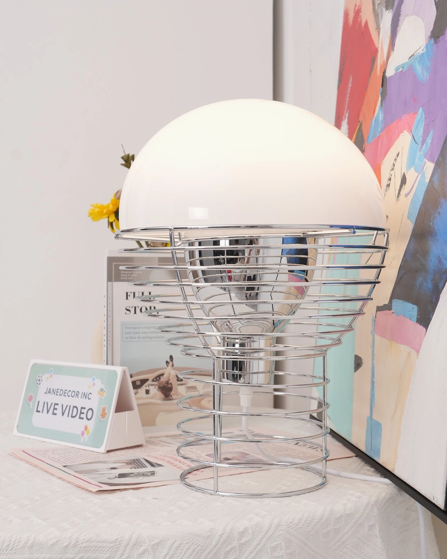 Chrome wire cage lamp right side close-up detail shot minimal tabletop background