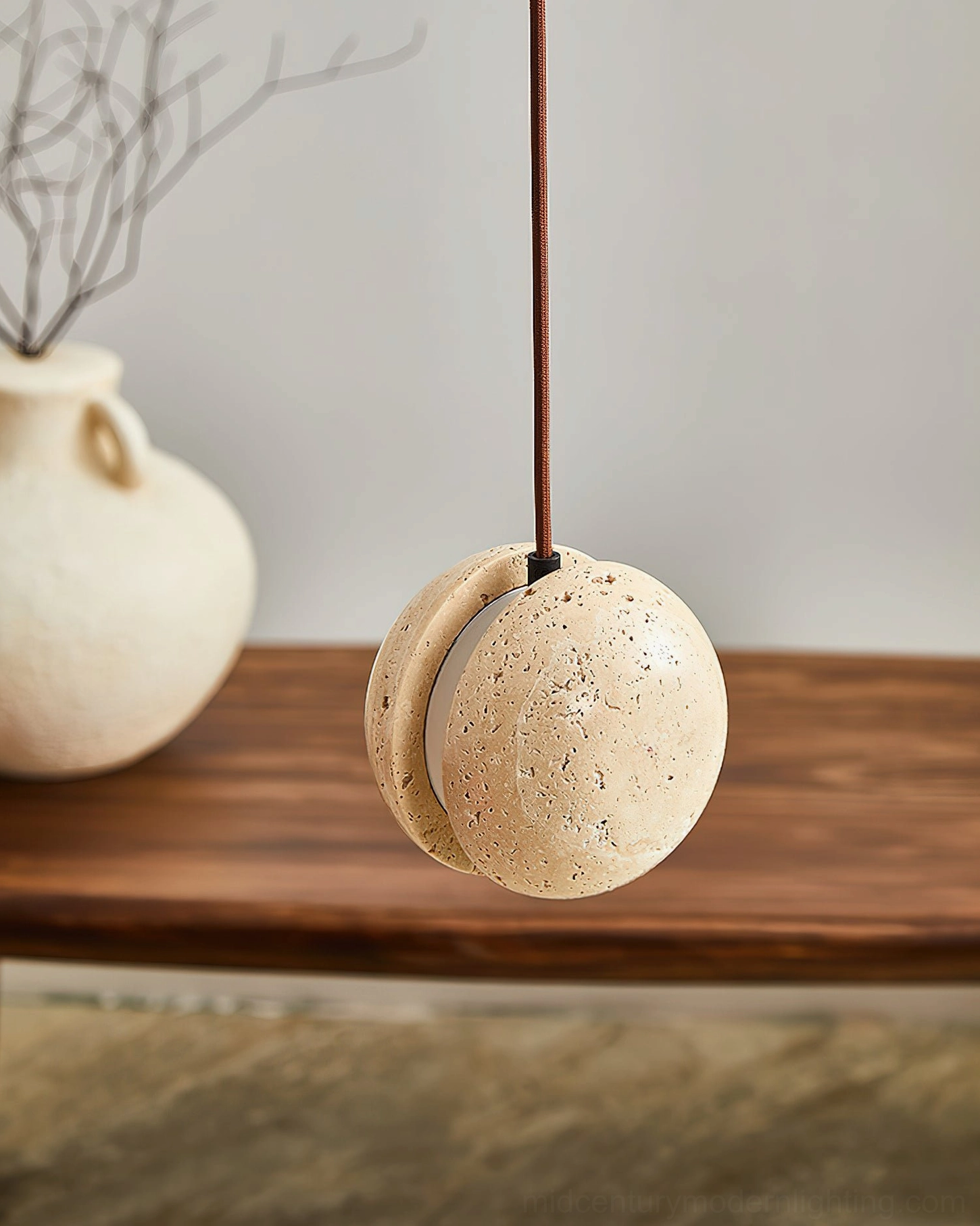 Wisteria travertine pendant lamp unlit close-up front view, ceramic vase styling, dining space detail photography