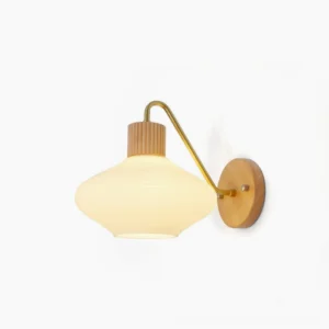 Wohlert Nordic wall sconce with ribbed frosted glass shade and brass curved arm on white background