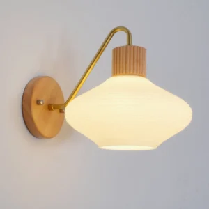 Wohlert wood and brass wall sconce mounted on indoor wall with curved arm detail