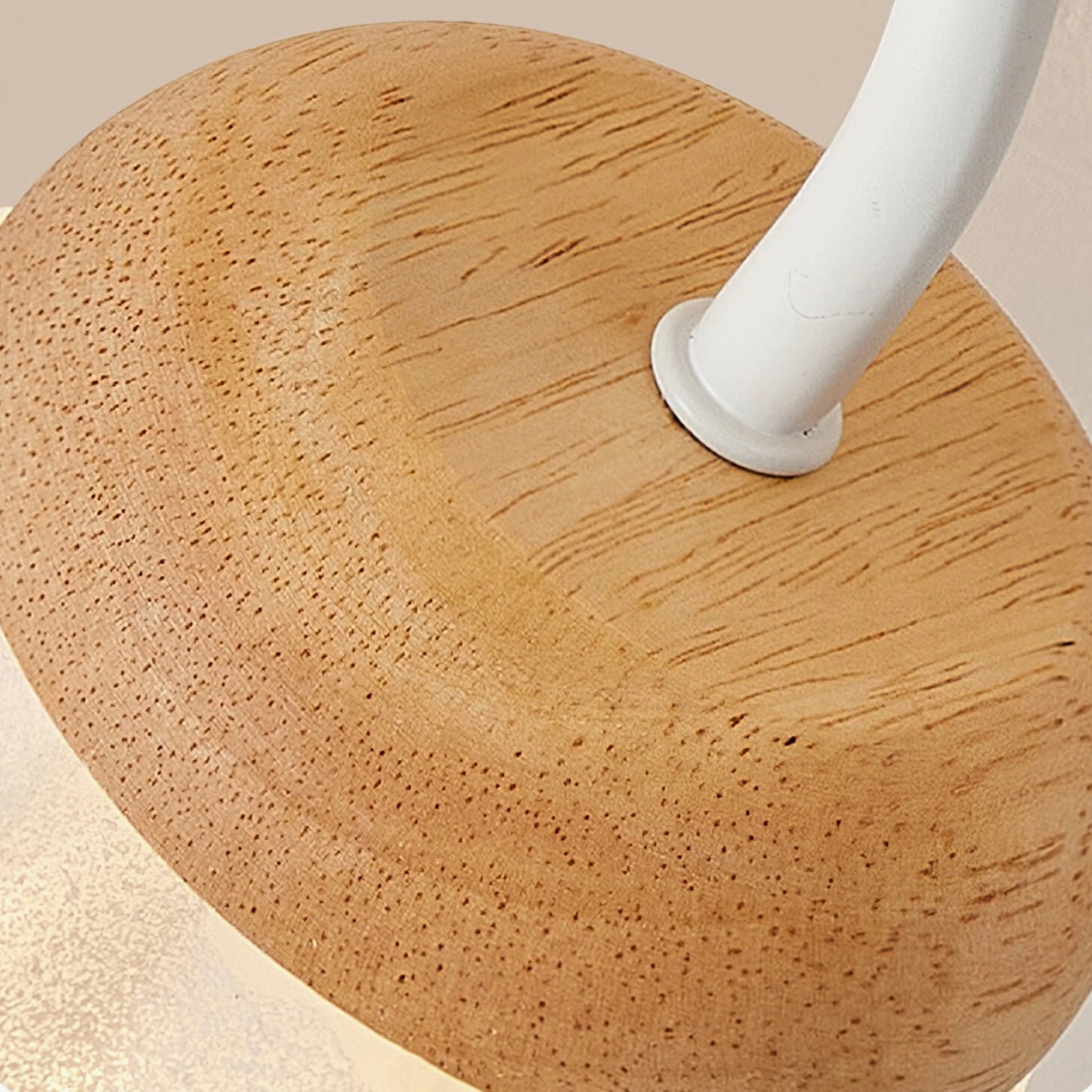 Wooden ceiling mount base with white metal suspension rod, solid grain detail