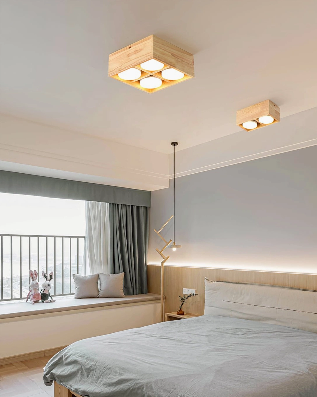 Square wooden ceiling lamps providing warm ambient lighting in Nordic style master bedroom with window bench