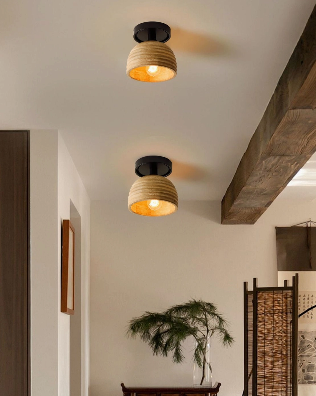 Dual ribbed wood ceiling lamps installed in residential hallway creating warm ambient lighting in rustic minimalist interior setting