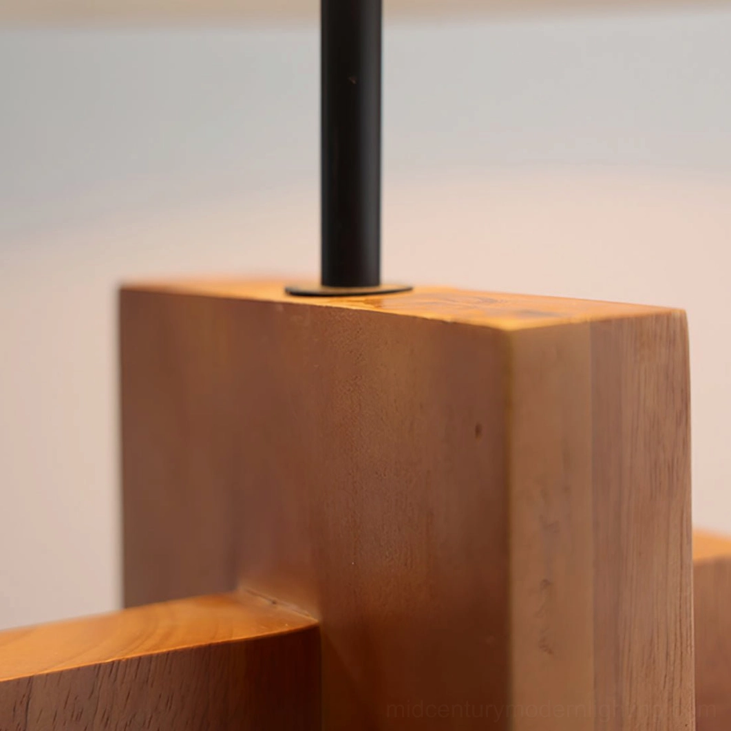 Low-angle detail of wood floor lamp connection showing solid wood and metal hardware craftsmanship