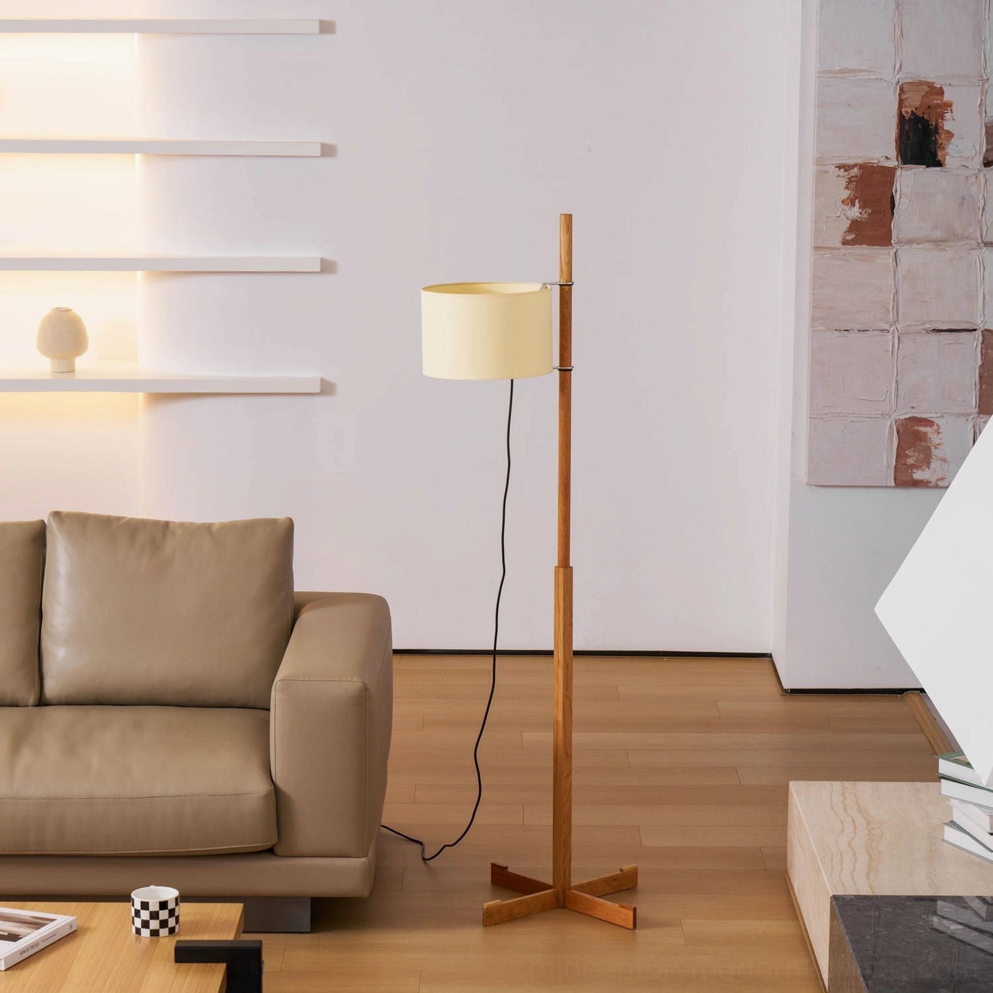 Wooden floor lamp with warm fabric shade in cozy Scandinavian minimalist living room