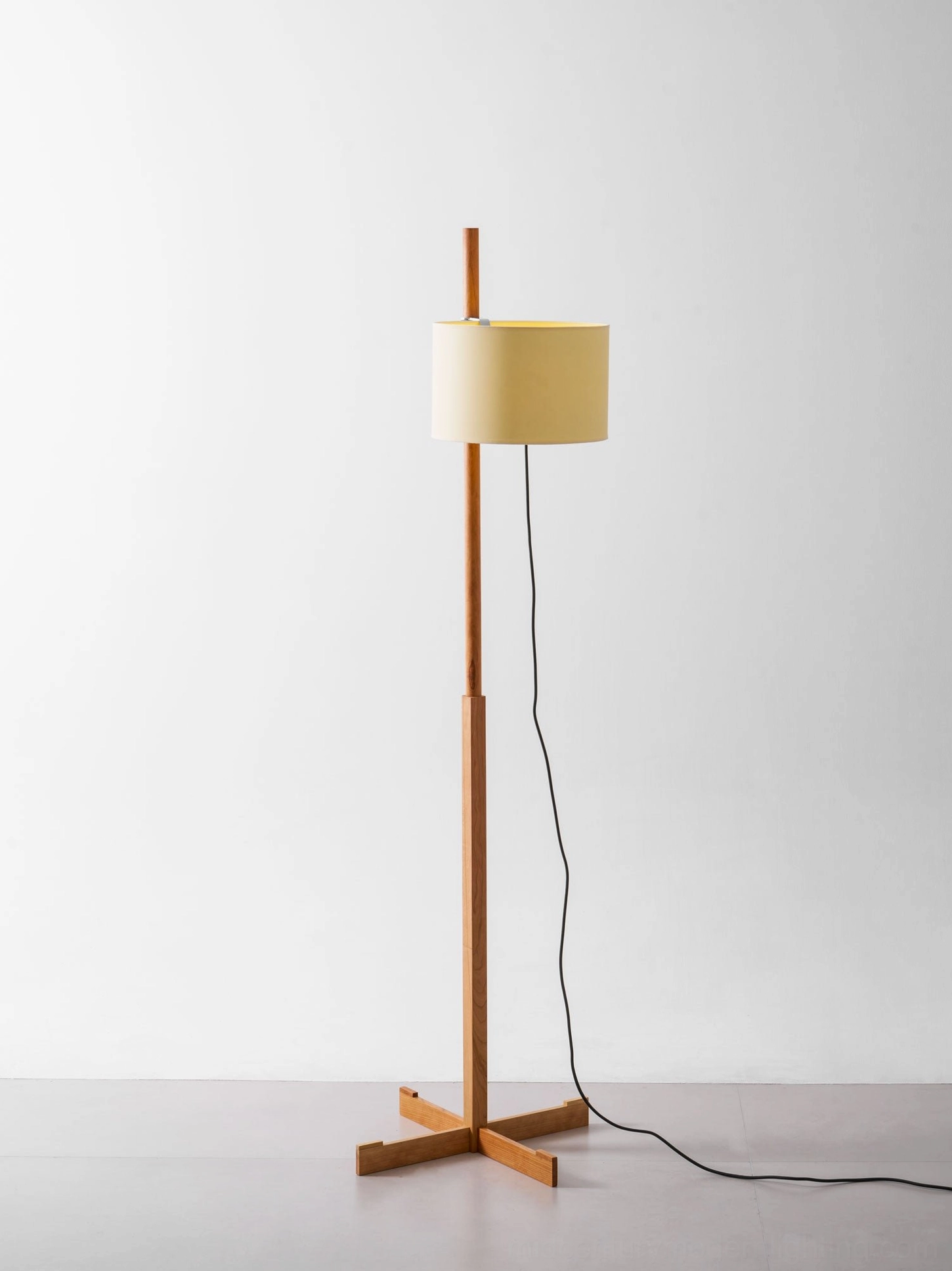 Wooden floor lamp detail highlighting minimalist aesthetic and wood grain texture
