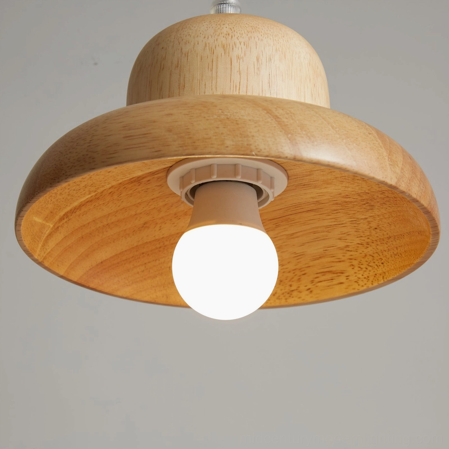 Bottom view of wooden pendant lamp showing exposed bulb holder and clear natural wood grain pattern