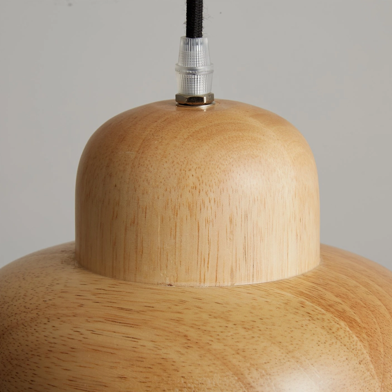 Natural wood pendant light fixture with warm glow demonstrating functional and decorative dual purpose
