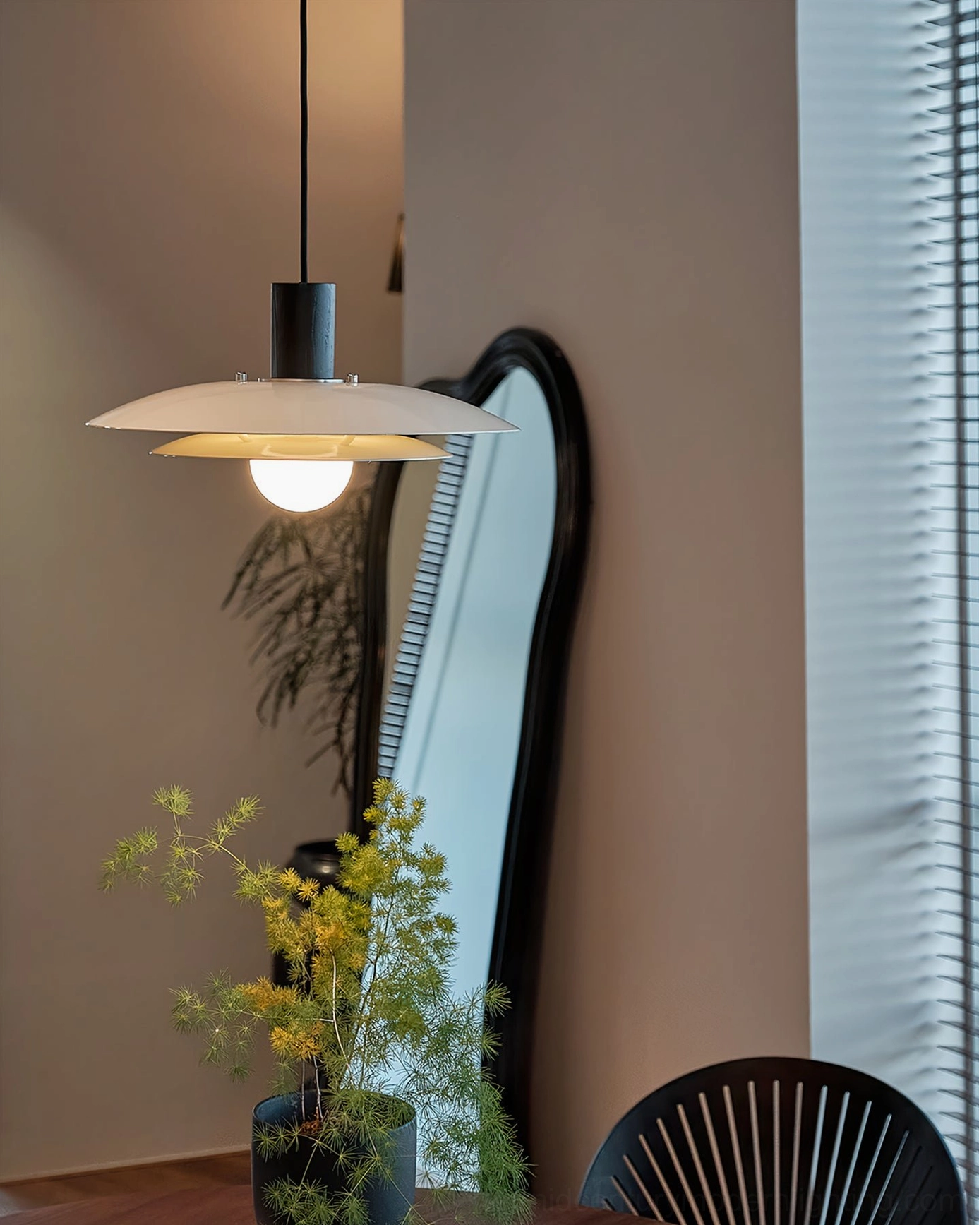 Wood pendant light with saucer diffuser showcasing warm light diffusion in residential dining environment