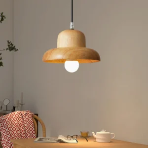 Minimalist wooden pendant light suspended in home study area above desk with warm neutral wood tone