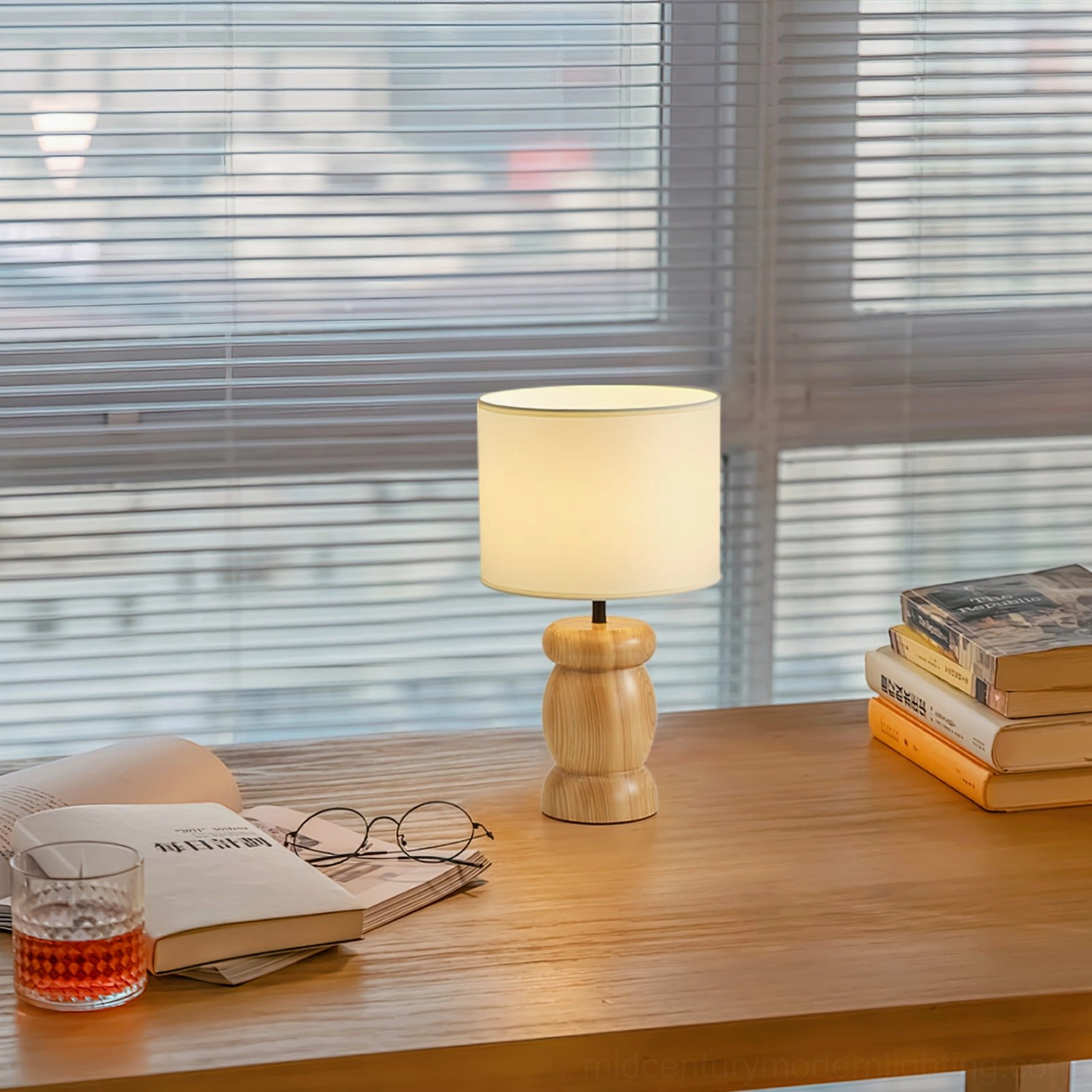 Pebble wood table lamp in home office setting with books and warm desk ambiance, wabi-sabi minimalist aesthetic