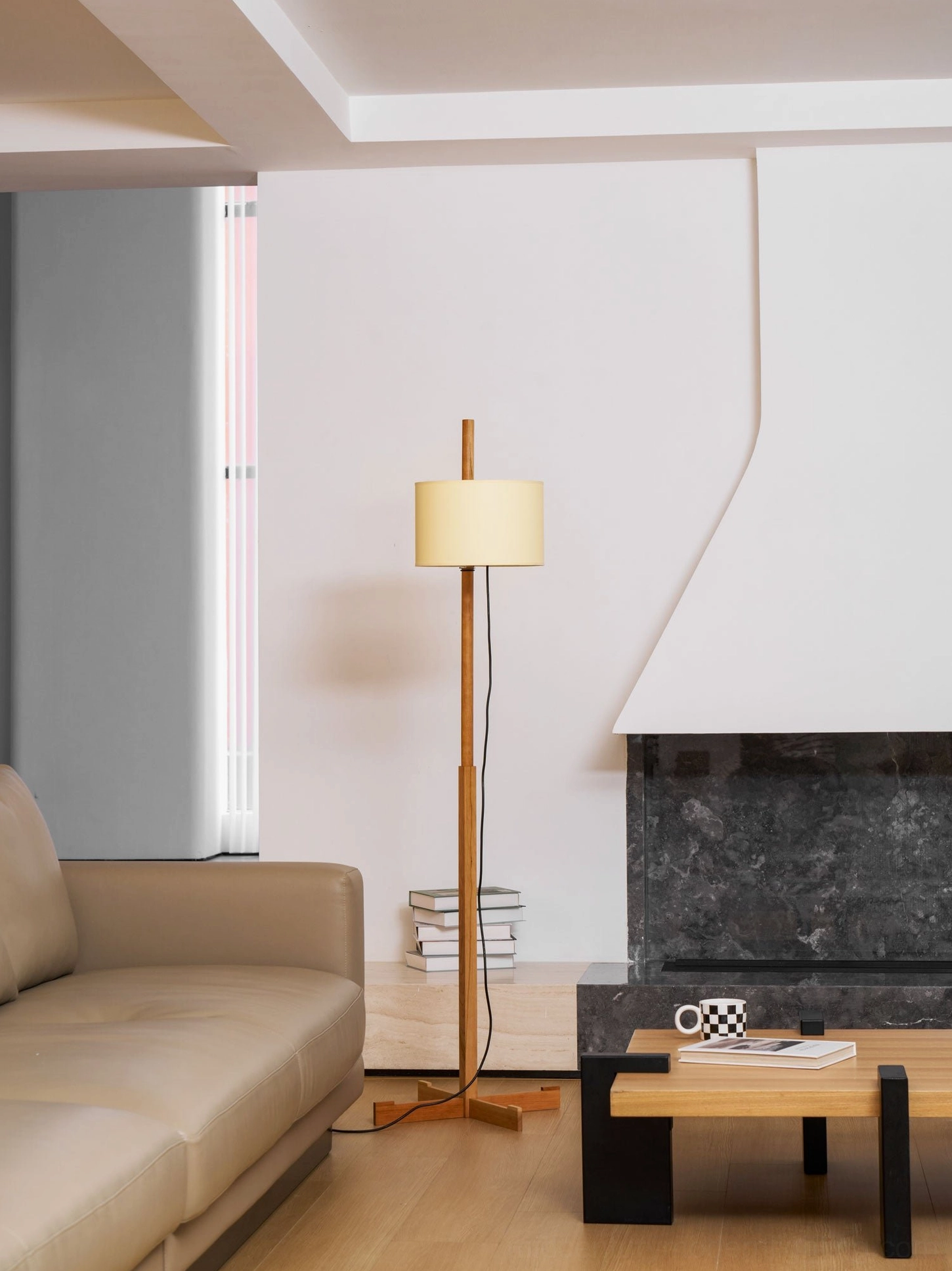 Low angle view of wooden cross-base floor lamp with fabric shade detail