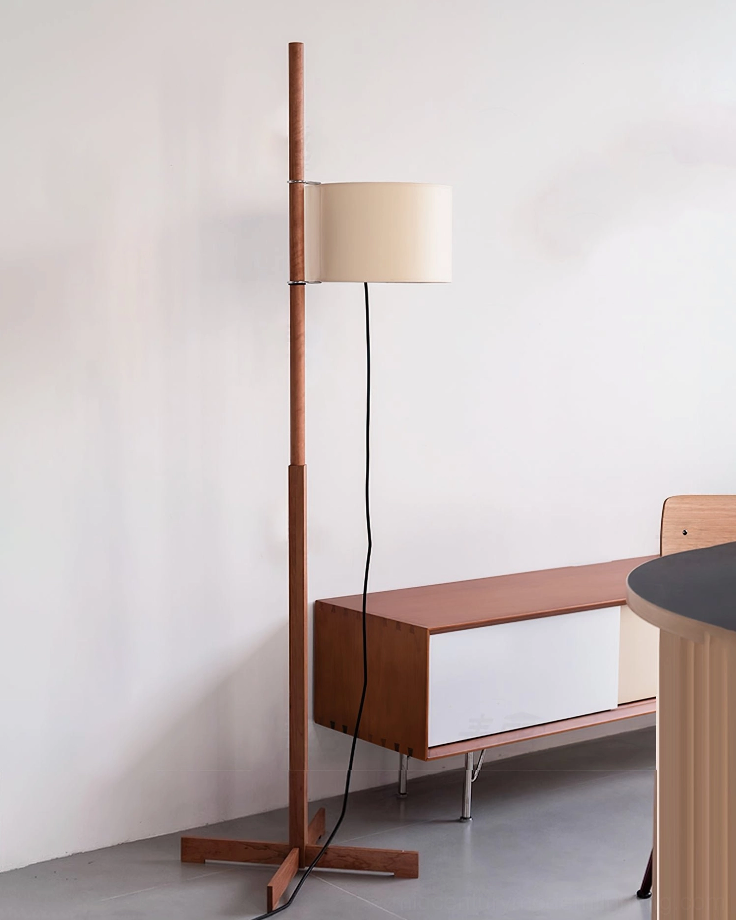 Full wooden floor lamp with cross base displayed in minimalist interior space