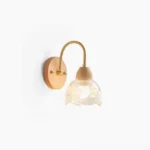 Wooden floral wall sconce with curved brass arm and etched glass shade, mid-century modern design