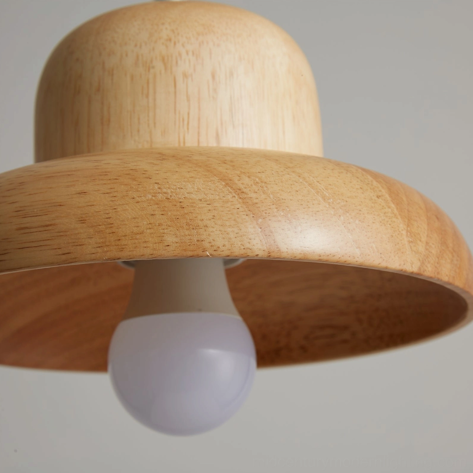 Wooden pendant lamp detail shot emphasizing organic wood grain and hand-finished surface quality