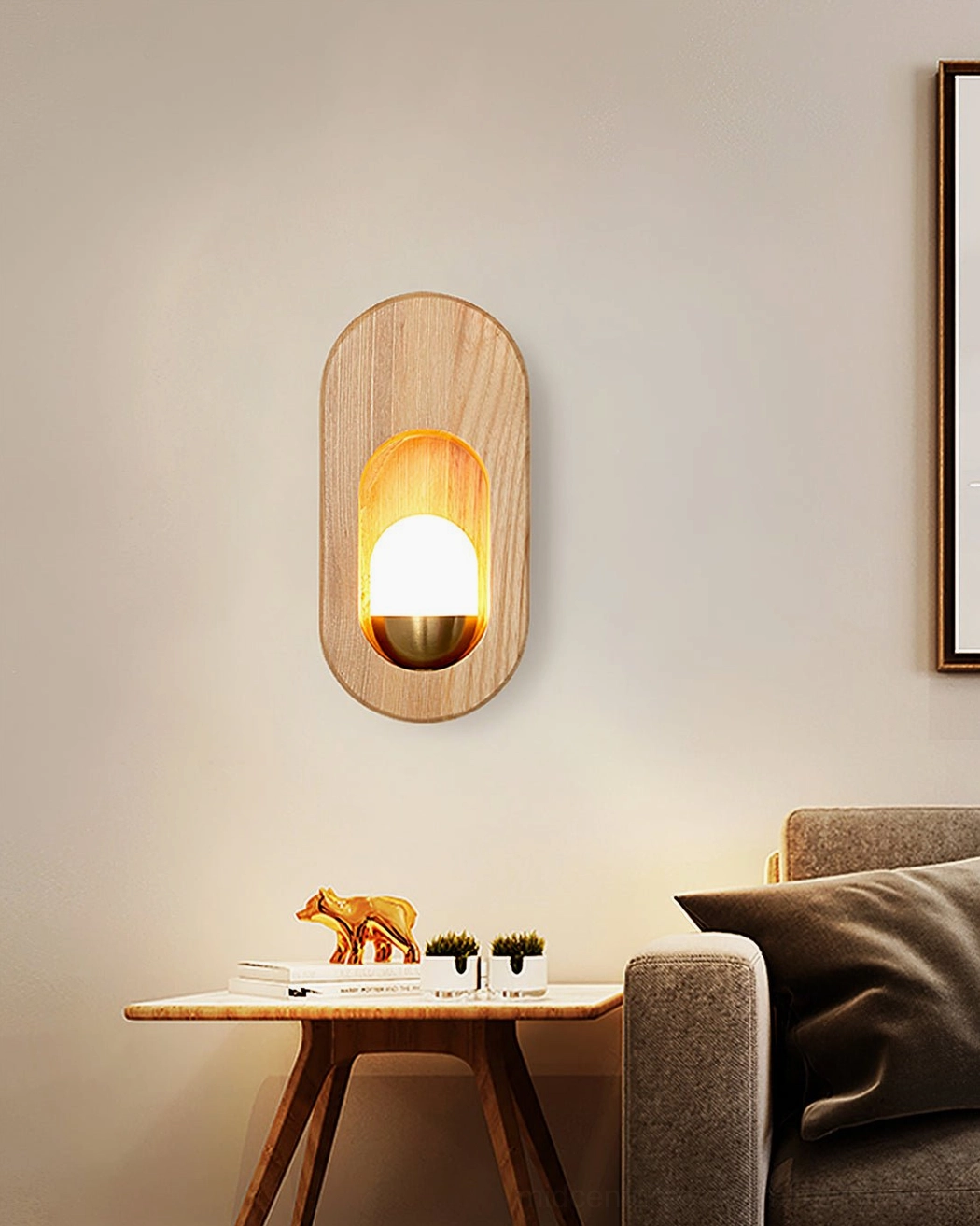 Wooden wall sconce accent lighting in living room near gray sofa with decorative ornaments