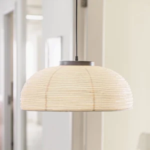Woven paper pendant light in modern hallway – soft warm glow through textured rice paper shade