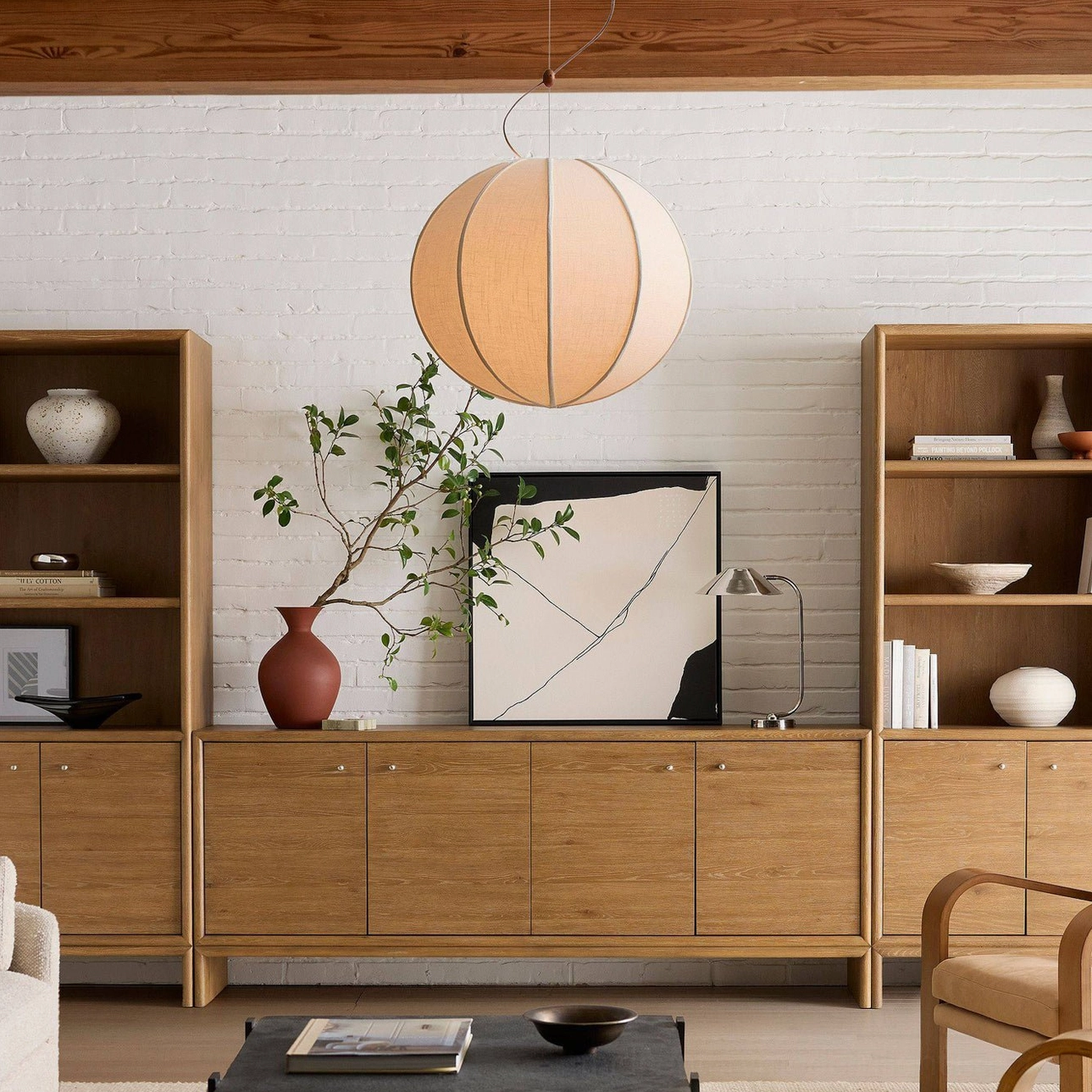 Warm beige Yaratam pendant lamp illuminated in Japandi-style living room with minimalist aesthetic