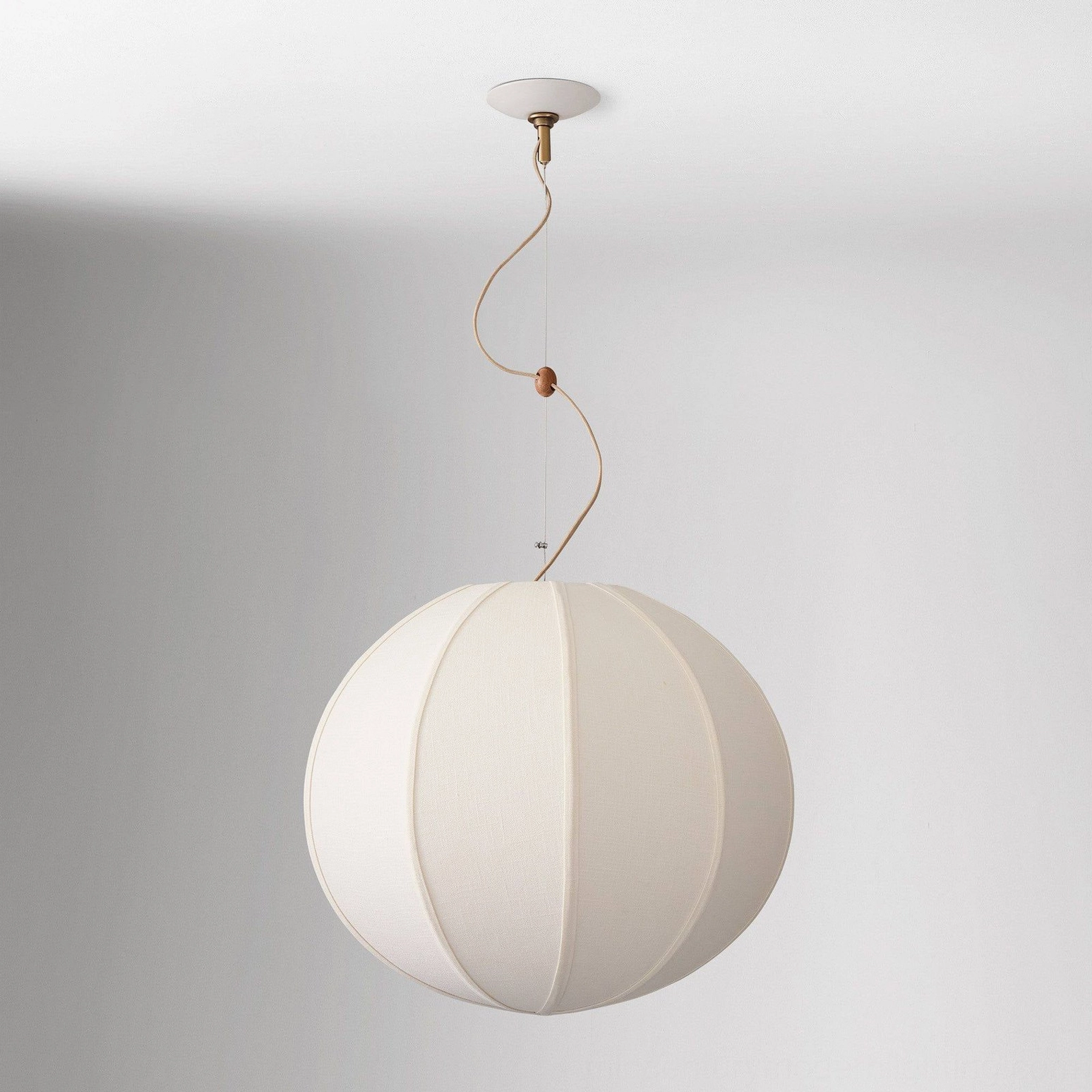 Overhead view of off-white Yaratam pendant showing twisted metal rod and fabric shade structure