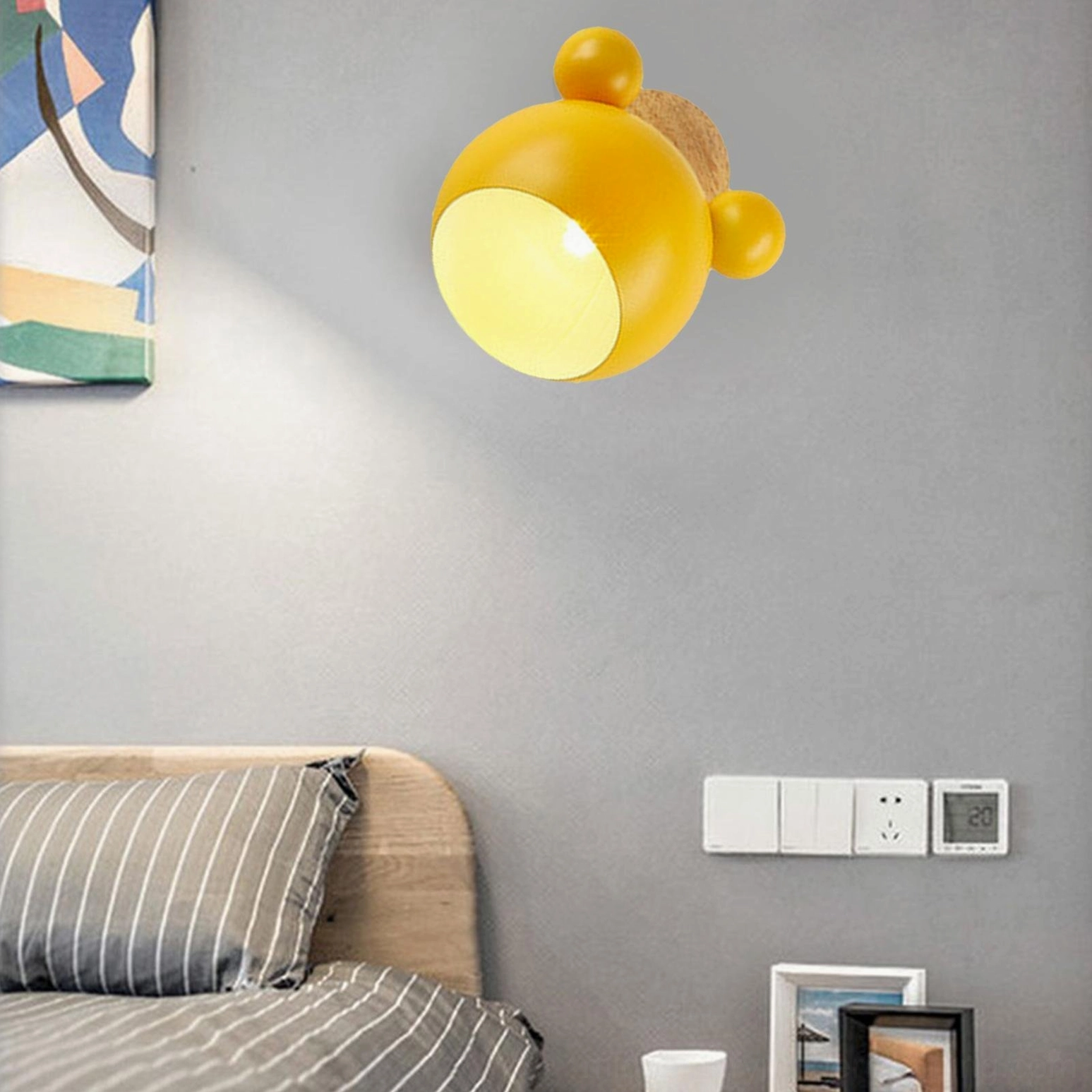 Illuminated yellow mouse wall lamp showing warm glow and rotatable design feature