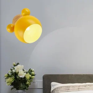 Yellow mouse wall lamp glowing in contemporary bedroom creating warm ambient lighting